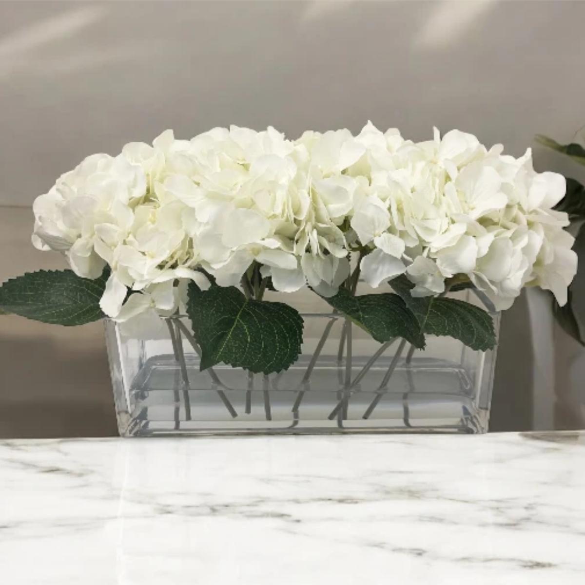 ARTIFICIAL HYDRANGEAS IN LONG RECTANGULAR GLASS VASE