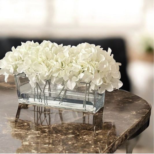 ARTIFICIAL HYDRANGEAS IN LONG RECTANGULAR GLASS VASE